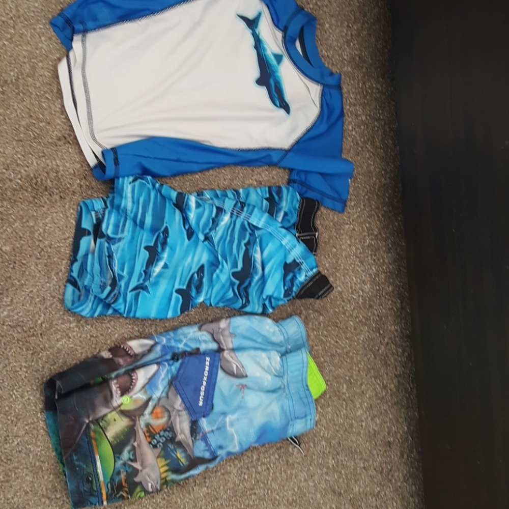 2 swim trunks. 1 rash guard top